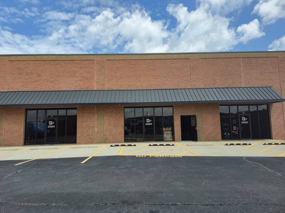 The Dojo storefront — brick facade with Units 105, 106, 107